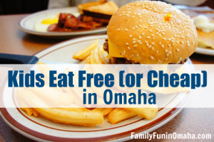 A sandwich and fries on a plate with overlay text that reads Kids Eat Free or Cheap in Omaha