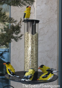 A group of birds at a bird feeder made from Lego blocks at Nature Connects Lego Exhibit at Lauritzen Gardens.