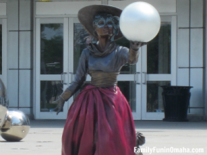 A statue of a woman holding a sphere at Century Link for the Omaha Photo Scavenger Hunt for kids.
