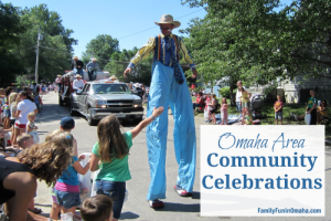 A person dressed as a clown on stilts walking in a parade with overlay text that reads, \"Omaha Area Community Celebrations.\"