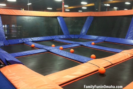 A group of trampolines with several plastic balls at Sky Zone Omaha Trampoline Park.