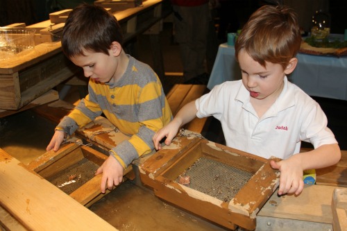 Two boys doing an activity at Dinosaurs Rock at The Omaha Children\'s Museum.