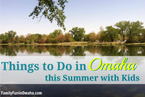 A body of water with a treelined shore with overlay text that reads Things to Do in Omaha this Summer with Kids