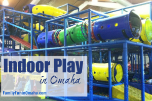 A large indoor play structure tubes with overlay text that reads Indoor Play in Omaha