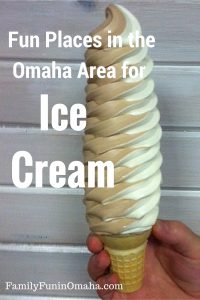 A very large chocolate and vanilla twist ice cream cone with overlay text that reads Omaha Area Ice Cream