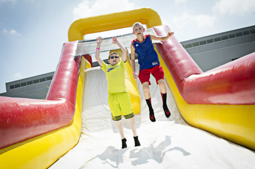 Two boys on a slide at BaconFest Omaha.