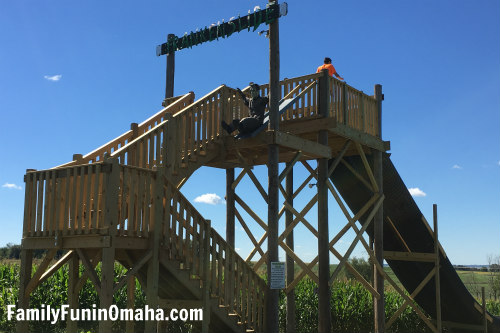A close up of the stairs and platform for a giant slide at Skinny Bones Pumpkin Patch.