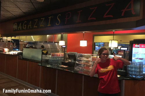 A team member in front of the check out at Ragazzi\'s Pizza.