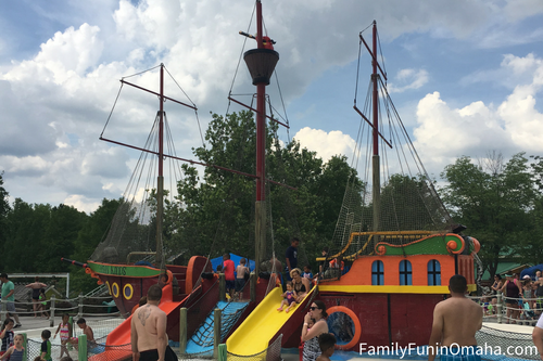 A group of people on a tall ship-shaped water slide at Oceans of Fun.