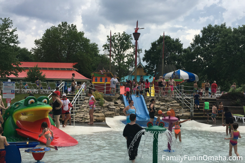 A group of people in a kids water area at Oceans of Fun.