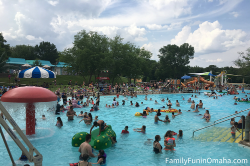 A group of people swimming in a wave pool at Oceans of Fun.