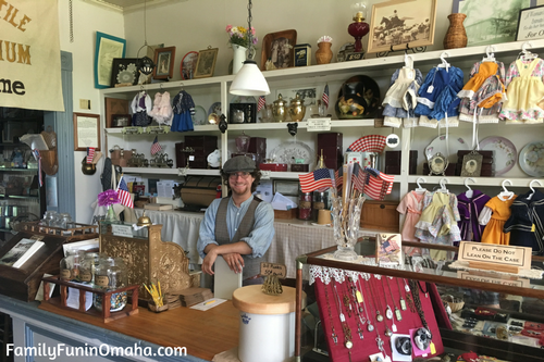 A clerk standing at the cash register at Stuhr Museum