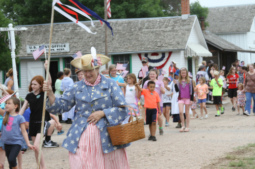 A group of people walking in a parade at Stuhr Museum