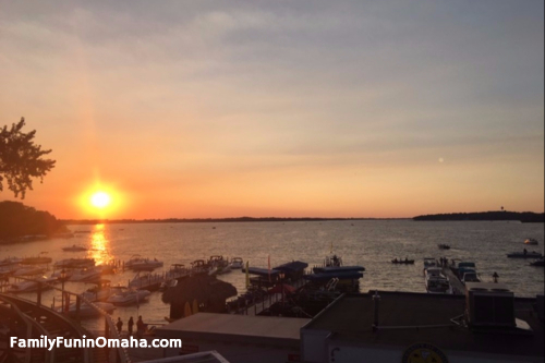A sunset over a body of water and boat dock at Okoboji