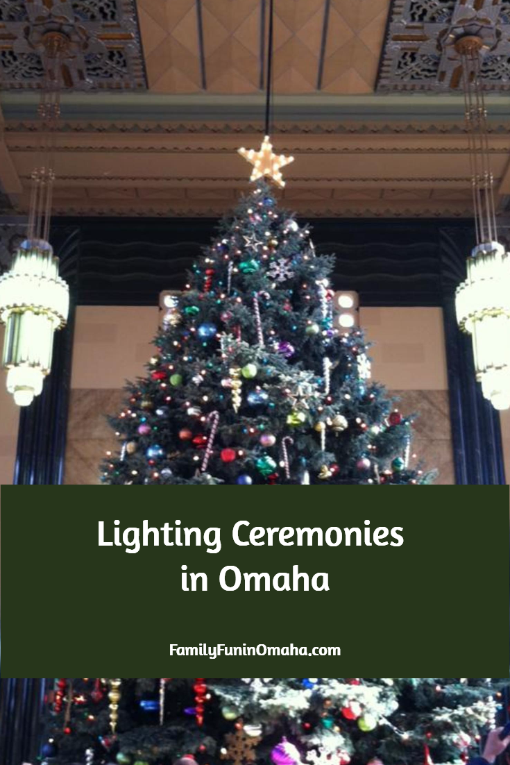 A large decorated Christmas Tree next to hanging lights