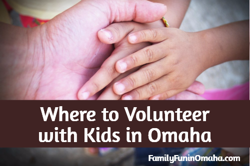 A close up of a group of hands with overlay text that reads, \"Where to Volunteer with Kids in Omaha.\"