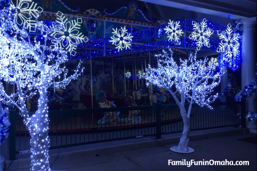 A blue and white Christmas lights display with trees and snowflakes at WinterFest Holiday Experience at Worlds of Fun.