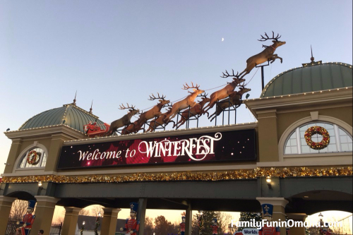 An entrance sign with a sleigh and reindeer at WinterFest Holiday Experience at Worlds of Fun.