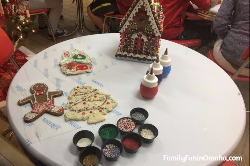 A gingerbread house and decorations on a table at WinterFest Holiday Experience at Worlds of Fun.
