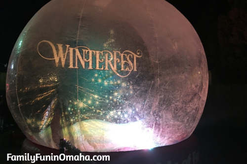 A large bubble that looks like a snowglobe at WinterFest Holiday Experience at Worlds of Fun.