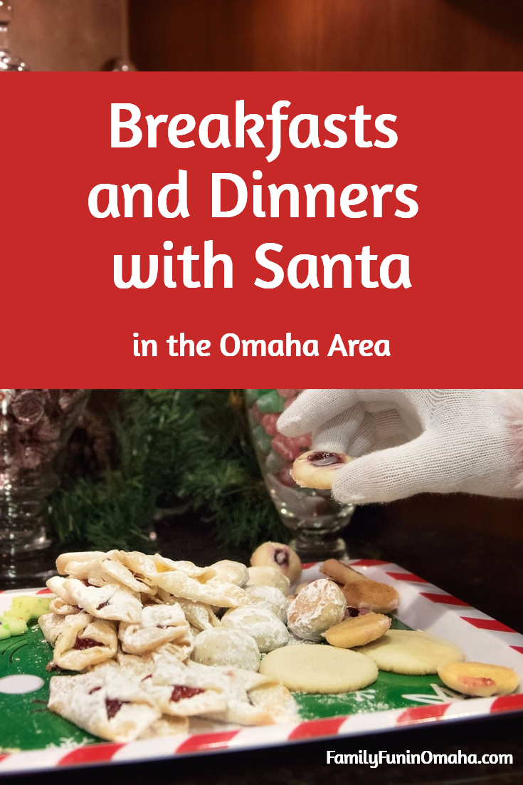 A close up of Santa\'s Hand choosing from a plate of cookies with overlay text that reads, \"Breakfasts and Dinners with Santa in Omaha.\"