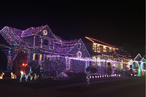 Houses decorated with Christmas lights at night