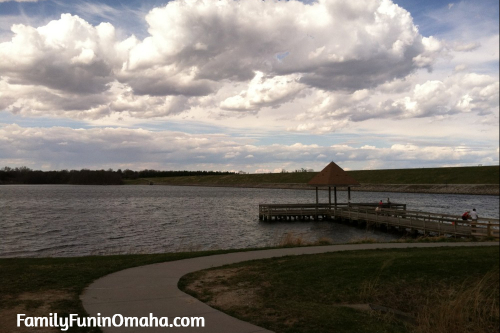 The pier and walking path next to the lake at Zorinsky Park