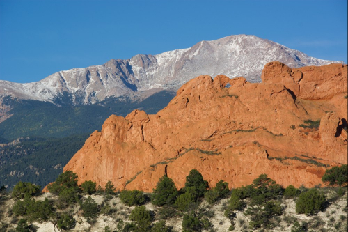 A stone formation with mountains in the background at Colorado Springs