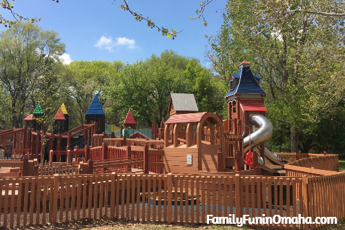 A close up of the large wooden play structure at Dream Playground