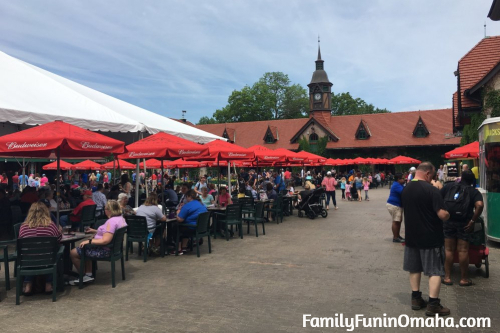 A group of people eating at covered outdoor tables at the St. Louis Grants Farm.