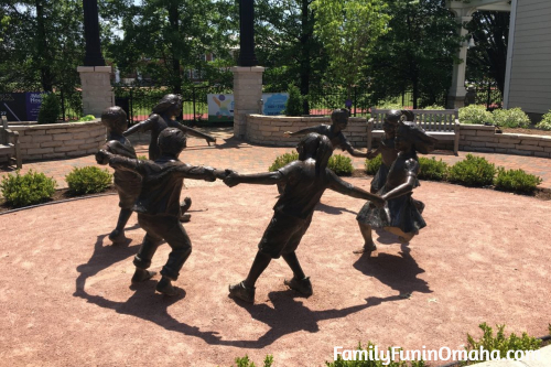 A bronze sculpture of children playing at the Saint Louis Zoo.