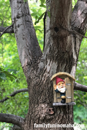 A close up of a little garden gnome on a tree at The Great Gnome Escape at Lauritzen Gardens.
