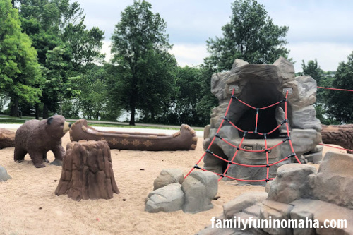 A rope climbing area and play canoe at Standing Bear Lake  Playground