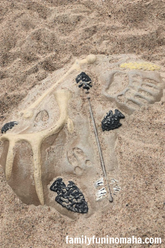 A play fossil pit at Standing Bear Lake Playground.