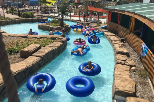 People in intertubes floating in a lazy river at Lost Island Waterpark.