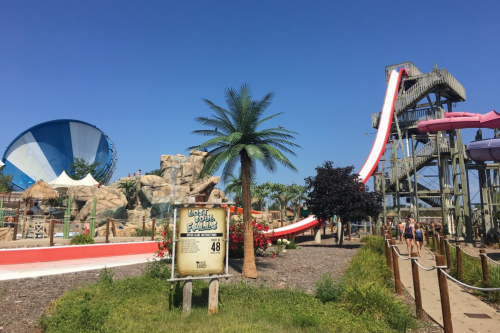 A sign next to a waterslide at Lost Island Waterpark.