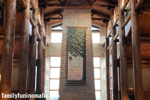 The inside of Arbor Day Farm showing a banner of a tree on a stone wall