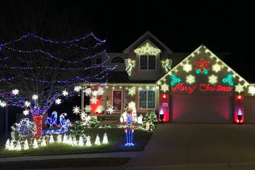 A house decorated with Christmas lights at night