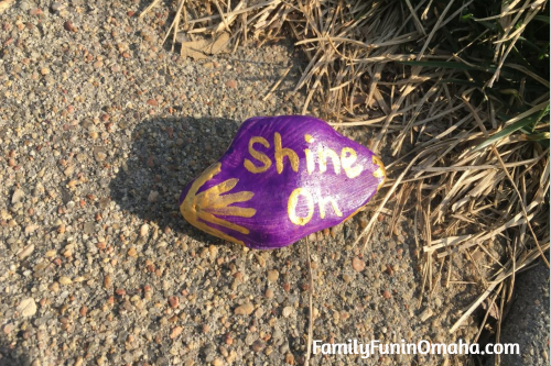 A close up of a painted rock that reads, \"Shine On.\"