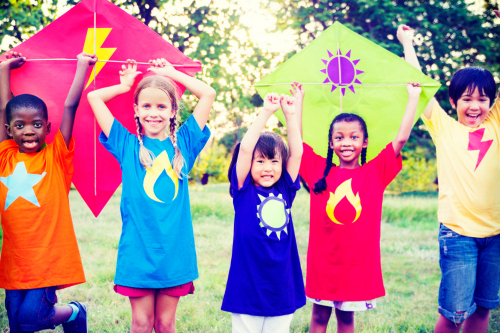Children holding kites outside
