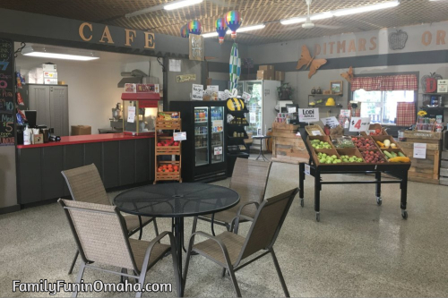 A table and chairs with displays at the cafe at Ditmars Orchard