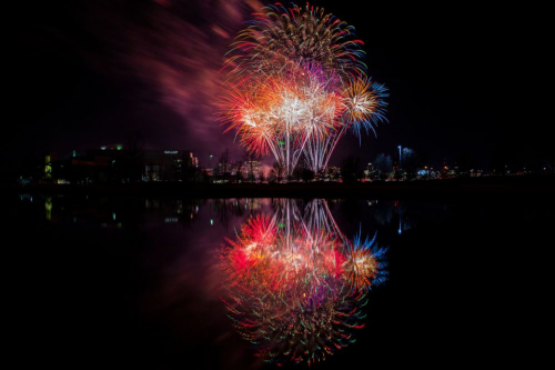 Fireworks reflecting in a body of water